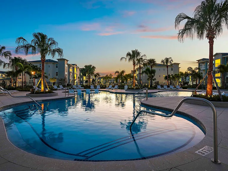 Unwind at this serene poolside oasis, perfect for relaxing and enjoying the evening sun.
