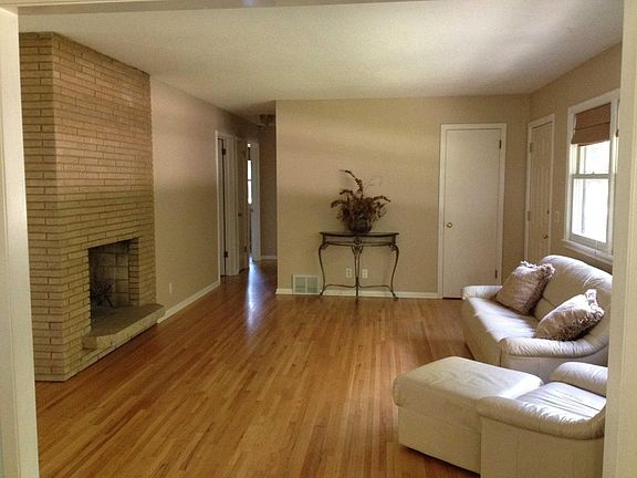 Living room with see through fireplace into eating area off