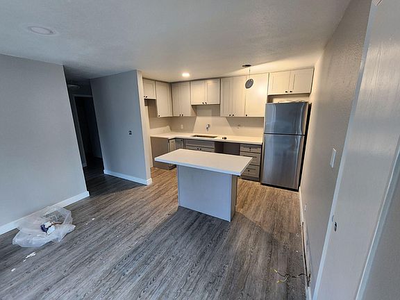brand new kitchen with all new cabinet, countertop, stainless steel appliances and an eat in island.