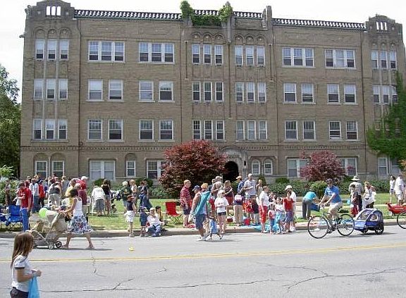 Front north view, during July 4th parade. 