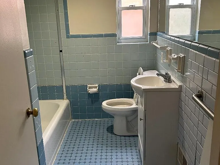 Bathroom with ceramic tile throughout, shower and tub