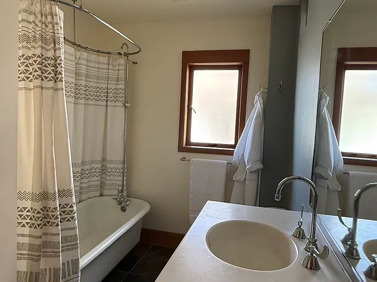 The second Bathroom with a large vintage bathtub.