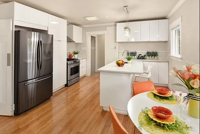 Contemporary kitchen with huge fridge and gas cooking! Lots of storage cabinets.