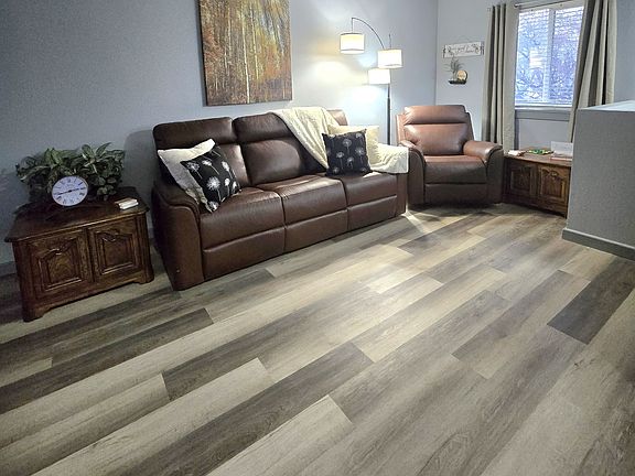 Living room with comfortable powered reclining furniture, fireplace and large TV w/sound bar