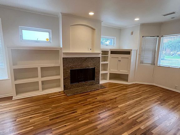 Bright, large living room with built in cabinets for more storage.