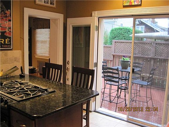 Sliding doors open from kitchen to outdoor dining