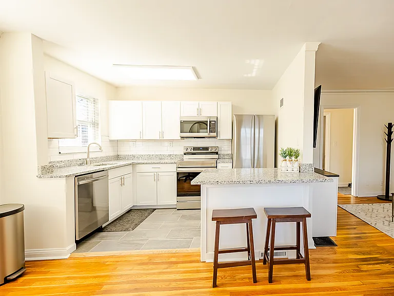 view of kitchen with barstools- perfect for sunday breakfast :)