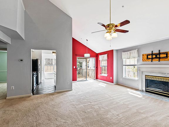Spacious living space with open living room, separate dining room, gas marble fireplace, and wall mount for TV.