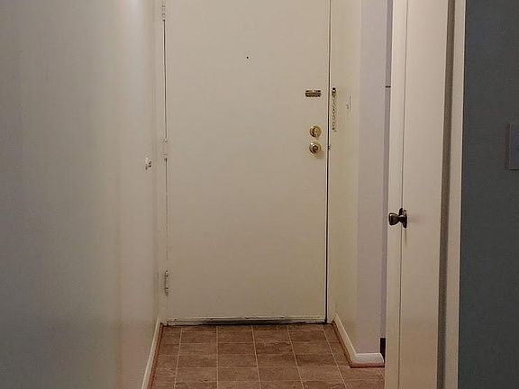 Entry hall with access to kitchen and a coat closet.