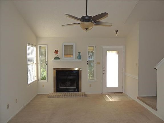 Vaulted ceiling in living offers a spacious feeling - Take note of custom front door and side windows by fireplace