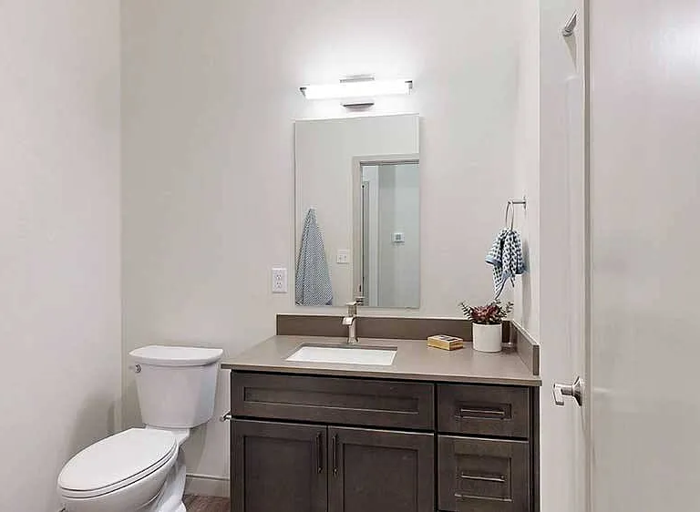 Start and end your day in this bright bathroom, featuring a clean and functional design.