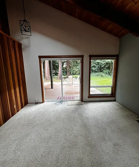 primary suite, sliders on both sides of bedroom to access decks