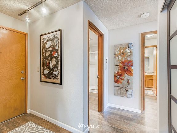 Dedicated entry with coat closet behind sleek doors with opaque glass. Bed and bath wing to one side while living spaces grace the other...