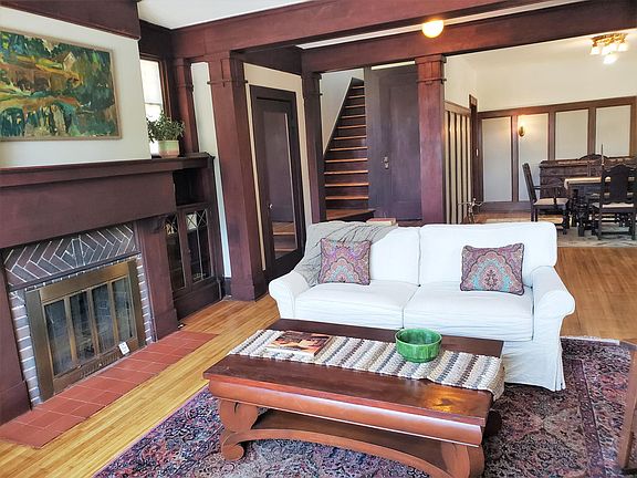 Spacious Living Room, which flows into elegant Dining Room. Staircase leads to 3 bedrooms, 1 full bath (tub and shower) upstairs, and seating area.