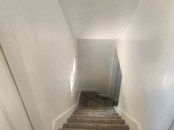 Stairs to basement. Due to tight turn, queen mattress only with base that can be broken down.