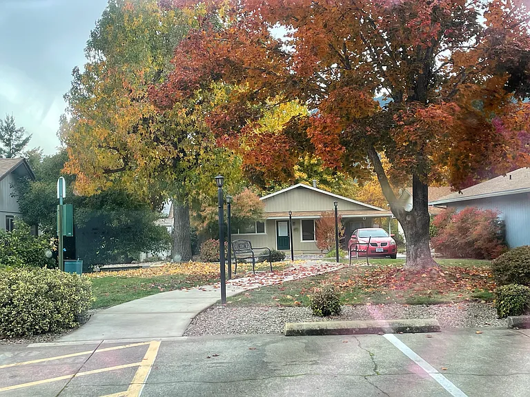Walking park with seating across the street with guest parking