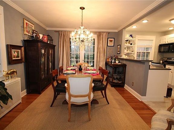 The dining room as seen from the living room showing the French doors and open kitchen.