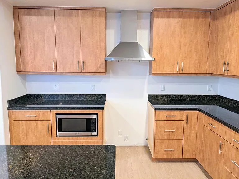 Open concept kitchen with gorgeous granite countertops, lots of storage including a lazy-susan shelf. Includes best-in-class Bosch Microwave. Brand New gas cooking range complete with oven will be installed soon.