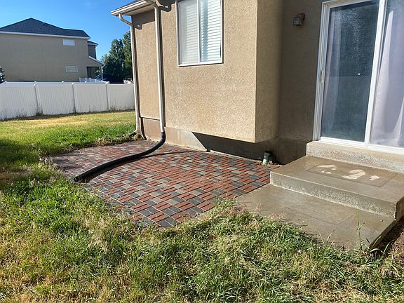 Back view of house with paved patio