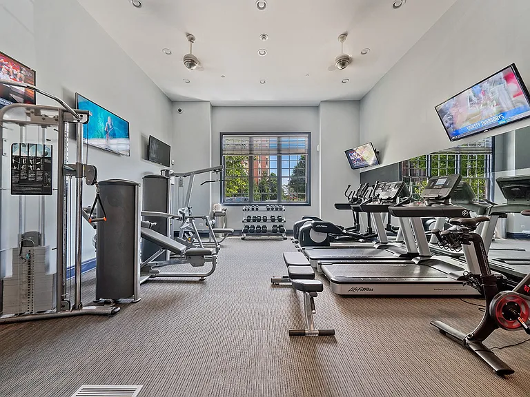 Spacious fitness center with treadmills and weights