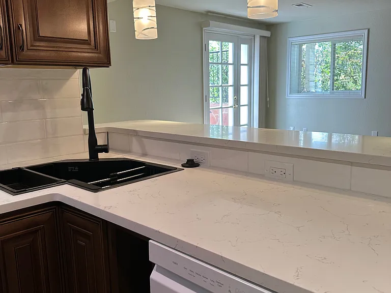 Butterfly sink overlooking south facing window and east facing entry door.