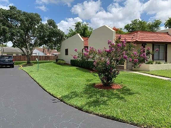 Corner townhouse with side grass area.