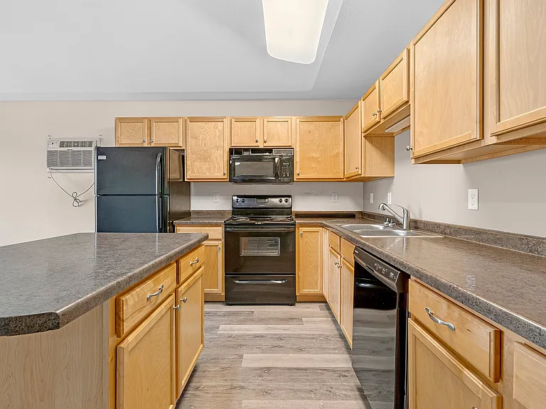 Elevate your culinary skills in the modern kitchen of Minot Place Apartments, featuring sleek appliances, ample storage, and stylish cabinetry. This is a space designed for both everyday meals and entertaining. Schedule your tour today!