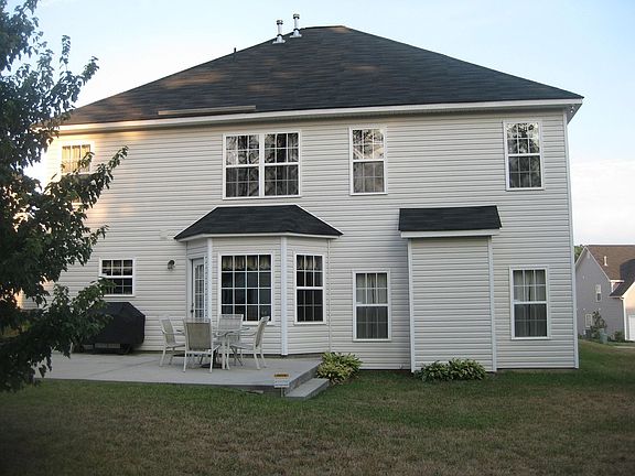 back of house- concrete steps up to extra large patio