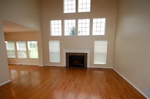A beautiful fireplace is surrounded by windows in the light and airy Great Room.