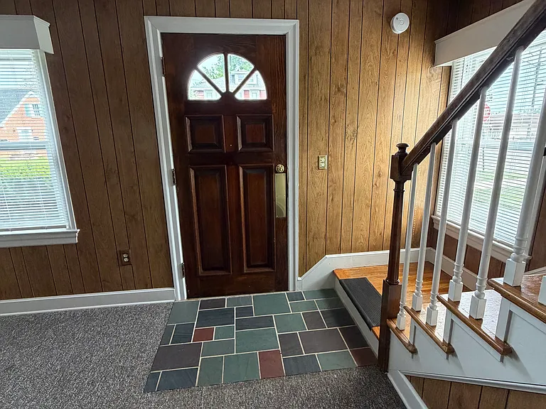 View of front entrance door, with slate tile entrance way.