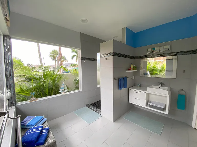 Very bright master suite bathroom. View of the palm trees. Not overlooked