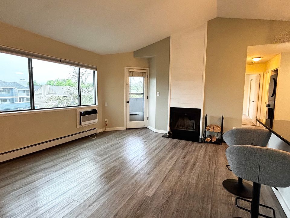 Open living area with wood-burning fireplace
