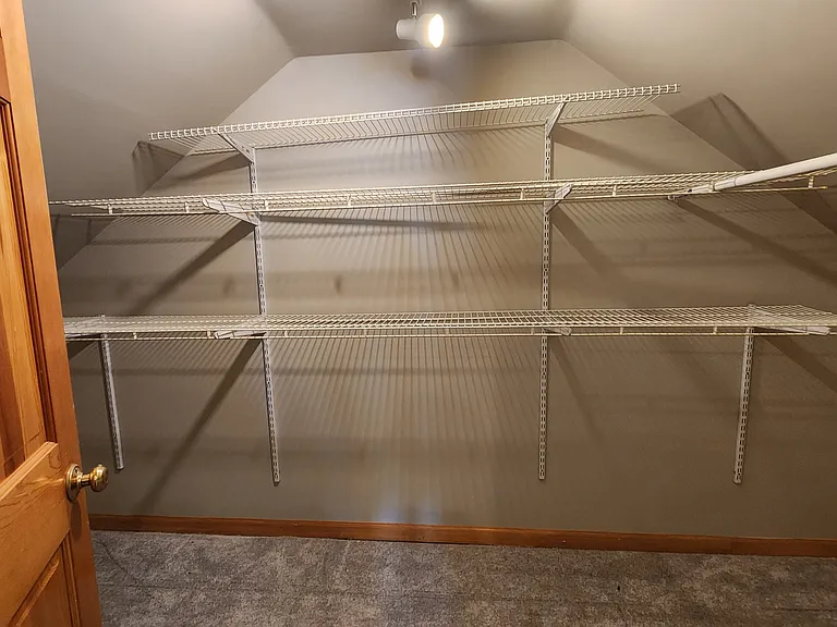 Primary bedroom walk-in closet