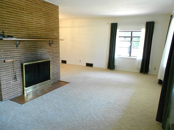 Living room with wood burning fireplace