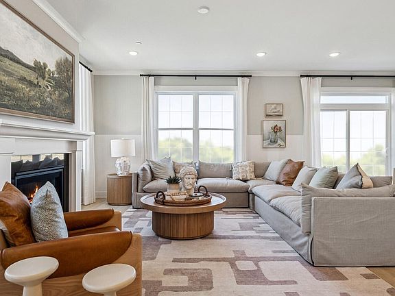 Great room with crown moulding and baseboard trim