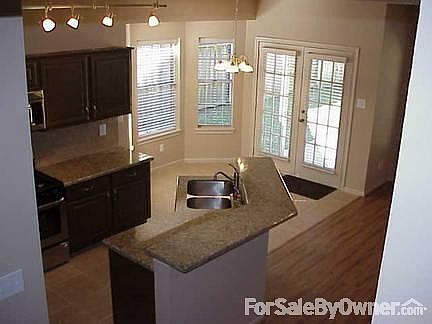 Kitchen From Stairwell
						:
						Overhead view from stairs shows the brightly lit
ALL NEW Kitchen