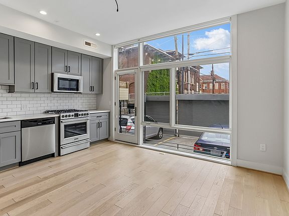 floor to ceiling windows offer abundant light. Pull-down curtains are installed.