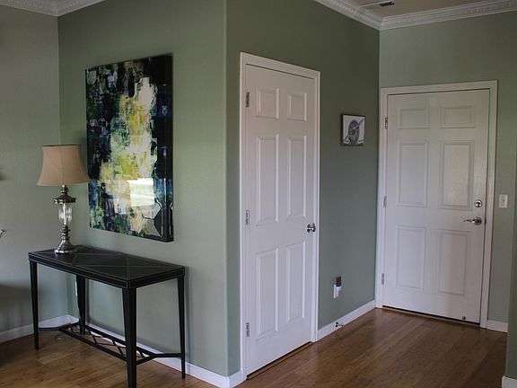 Entry room foyer. 1/2 bath inside left door, garage entry through right door.