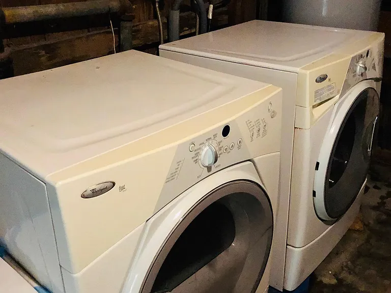 Washer and dryer in storage room.
