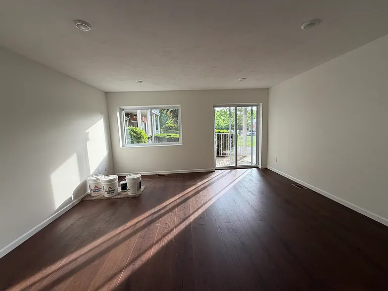 Sun filled living room with brand new flooring, paint & recessed lighting