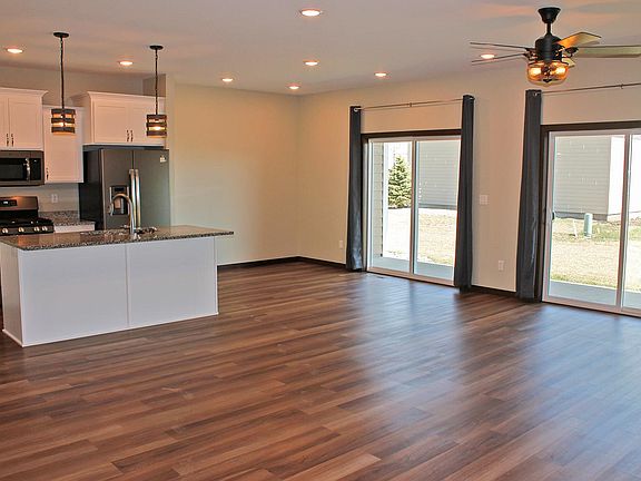 Living Area - both patio doors have been adorned with vertical blinds and curtains removed.