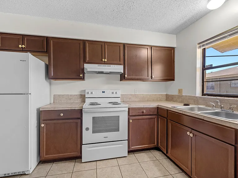 Kitchen with fridge, stove, oven and rangehood
