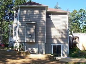 View from side of home. Glass door enters into almost finished basement.