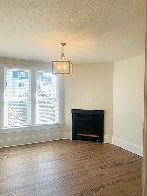 Beautiful living room with natural light from South facing windows & cozy gas fireplace.