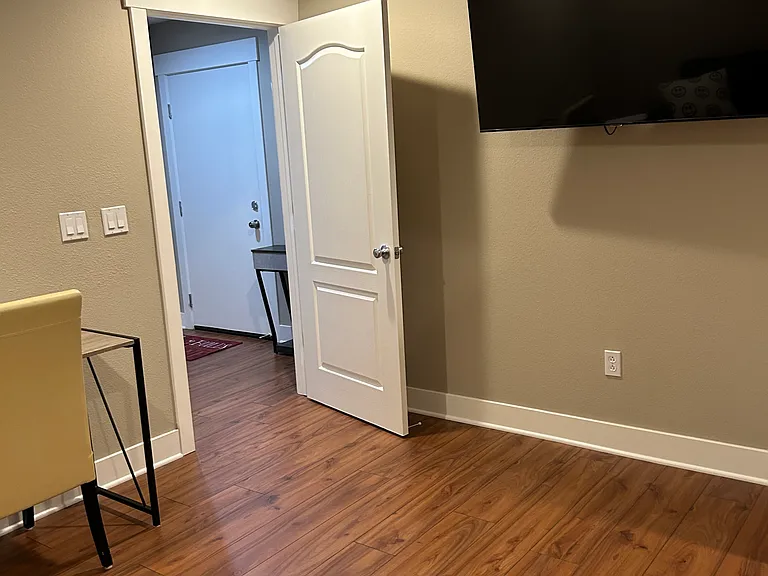 Downstairs/bottom level game room with TV, sofa bed, study table and chair