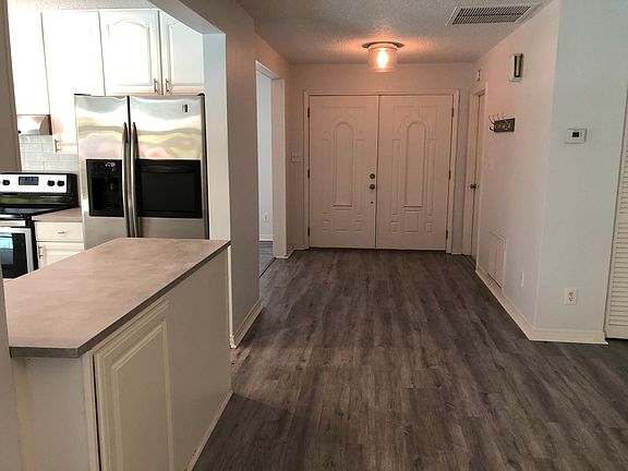 View of Front Door from Family Room, Living Room & Kitchen on left, Garage door on right