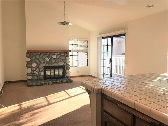 Upstairs Kitchen with stainless steel appliances and second fireplace leads to new balcony.