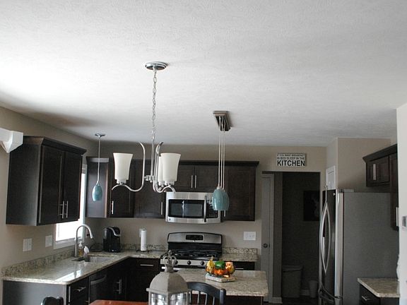 The "Great Room" concept is the only way to go. This look from the family/living room area to the kitchen. The patio door on the left leads to the deck.