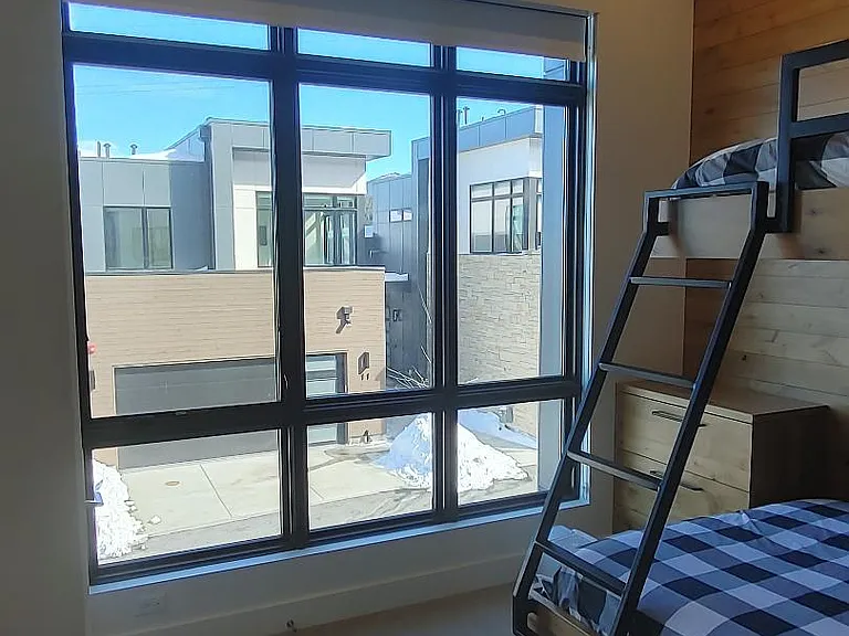 Custom built bunk bed room accommodating 3, queen bed on bottom and twin on top. 14 foot ceilings.