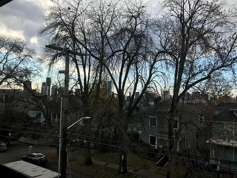 West facing living room window with view of Downtown, Space Needle, Puget Sound, and Olympic mountains